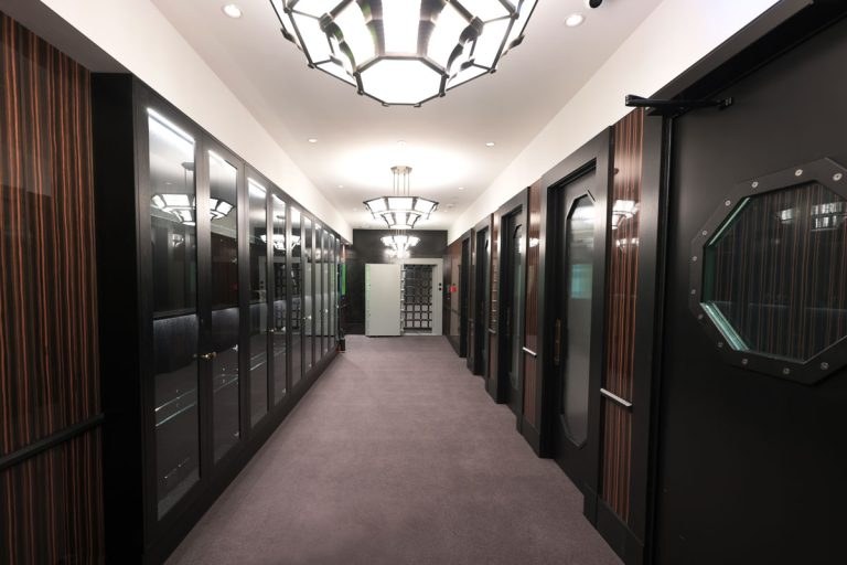 The corridor to the private viewing rooms at Hargreaves Street, with timber-lined doors and soft lighting.